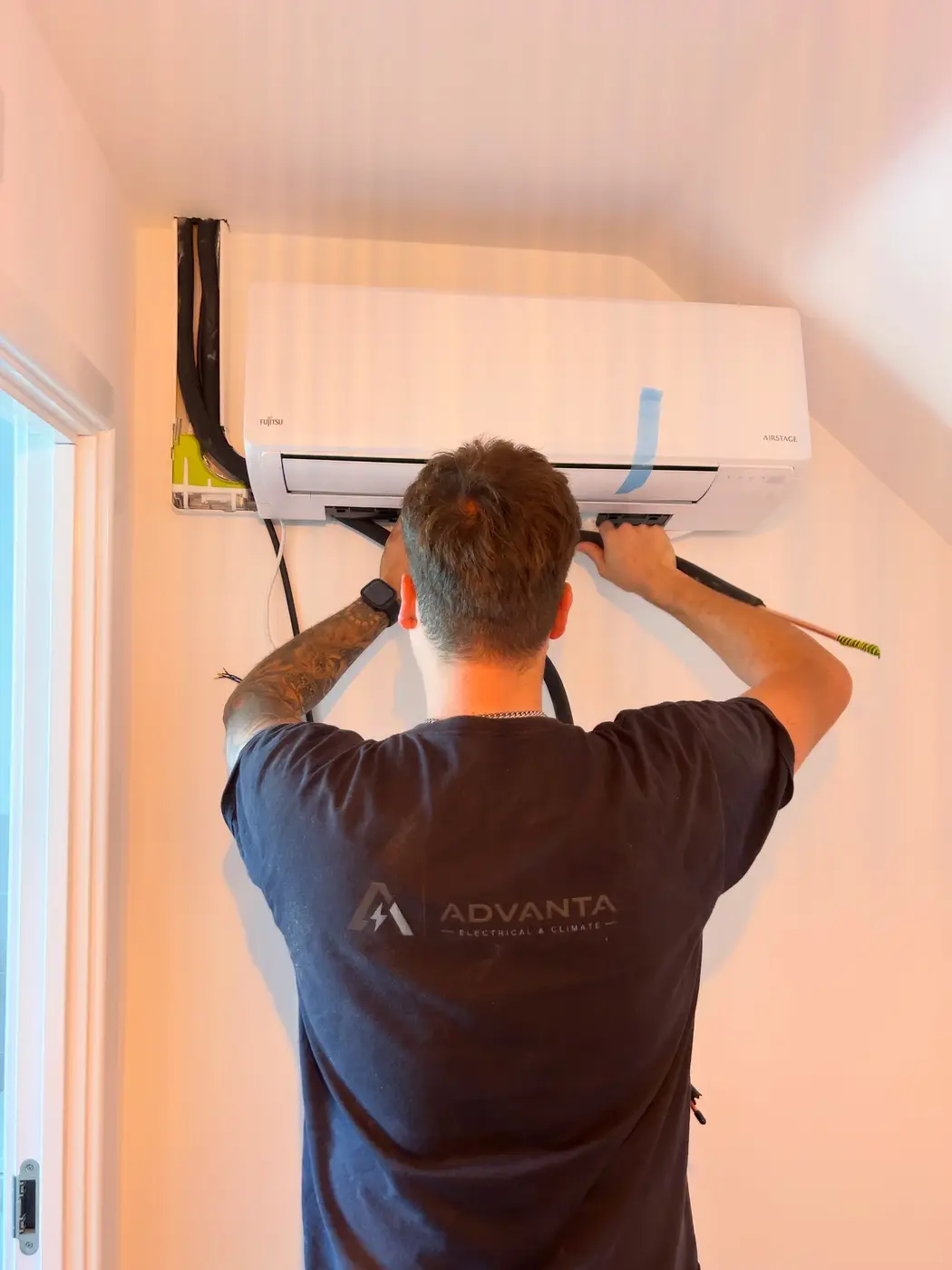 Engineer working on a Fujitsu air-conditioning system