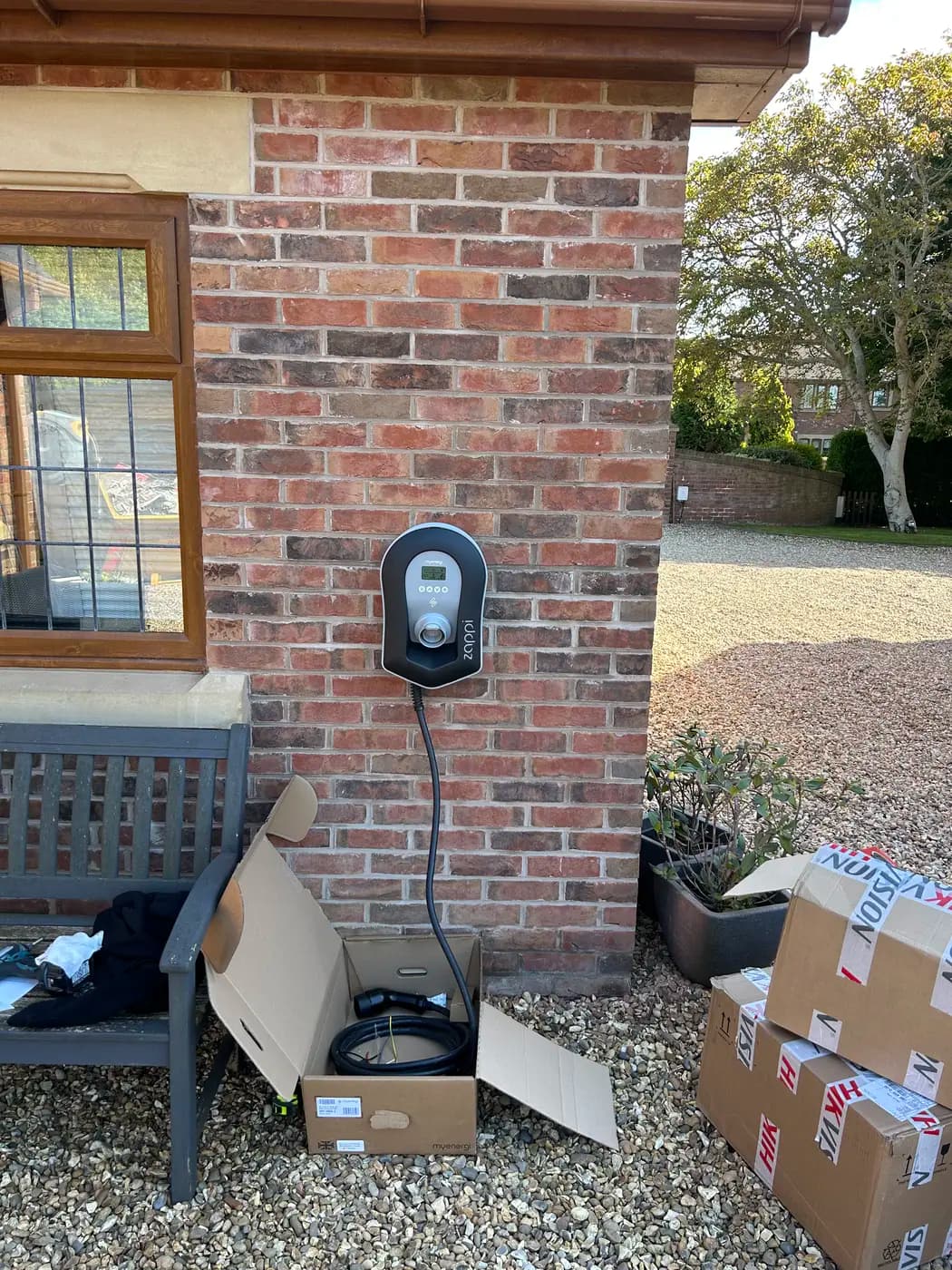 Rolec home EV charger on a brick cottage