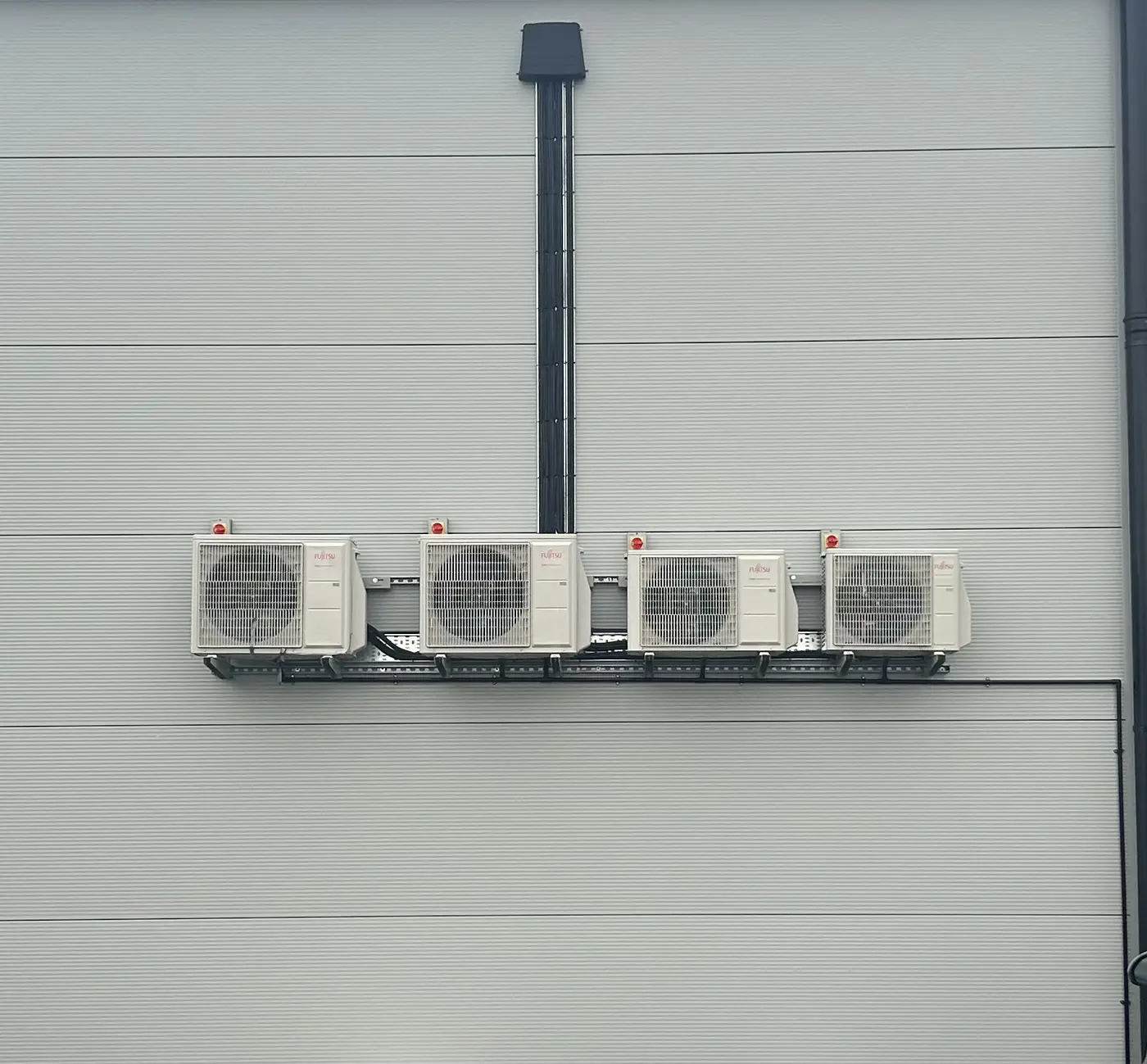 Four Fujitsu outdoor units on a commercial install