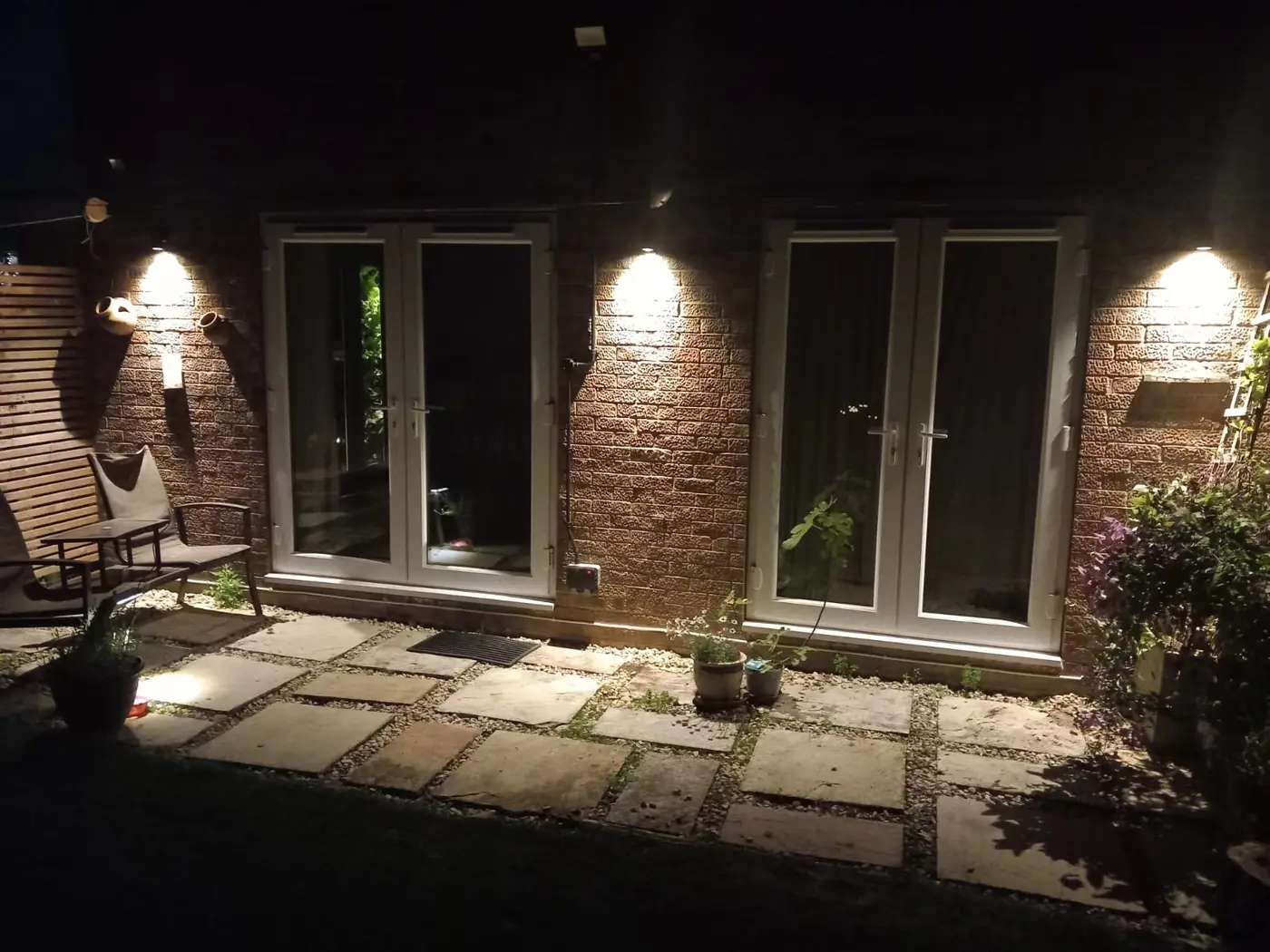Outdoor wall lights on a patio at night