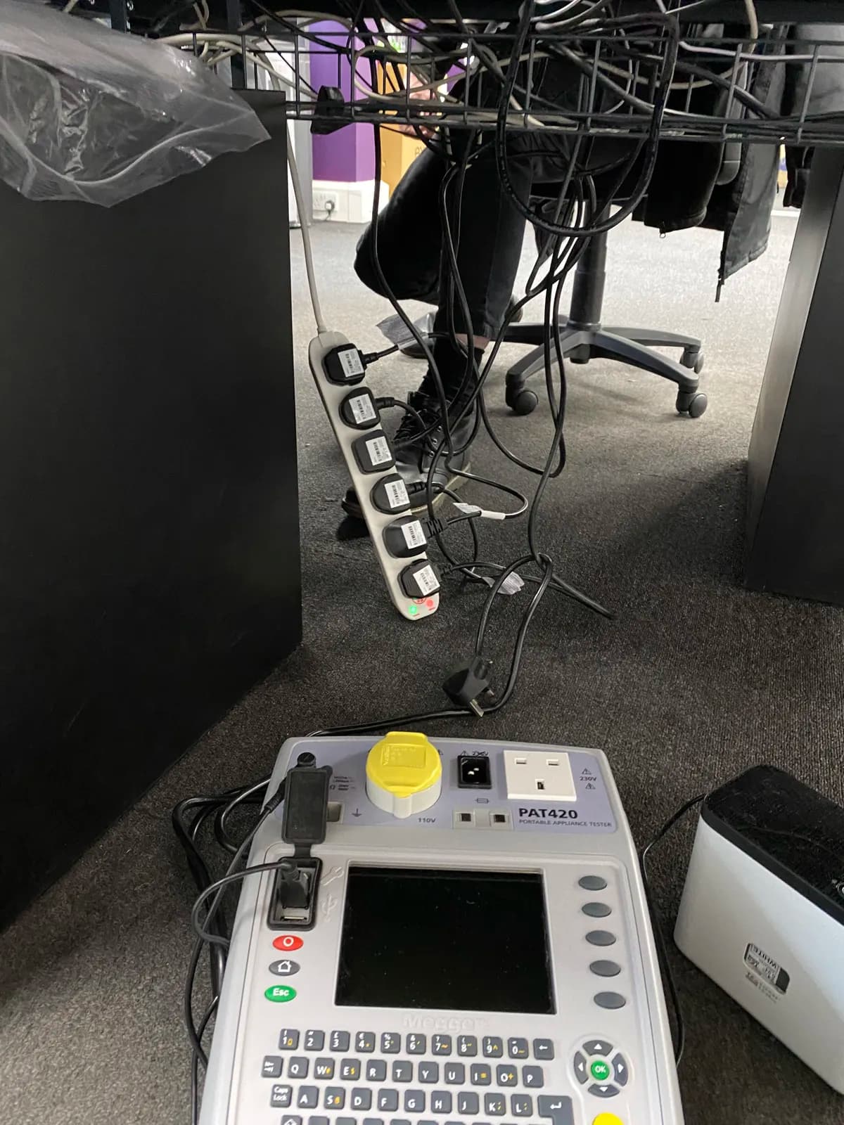 PAT tester and labelled extension lead during portable appliance testing