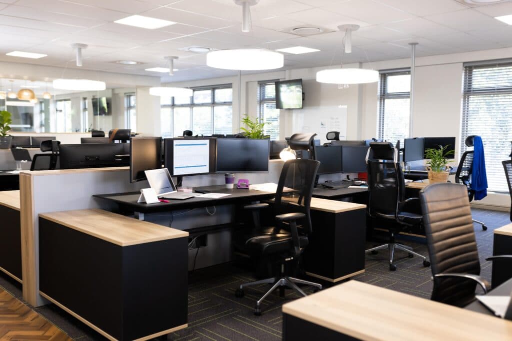 Open-plan UK office with desks, monitors and chairs