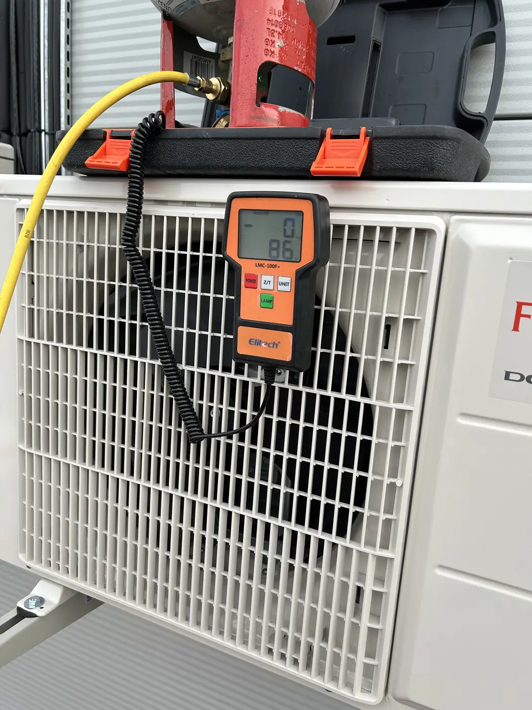 Outdoor air-conditioning unit being serviced and charged