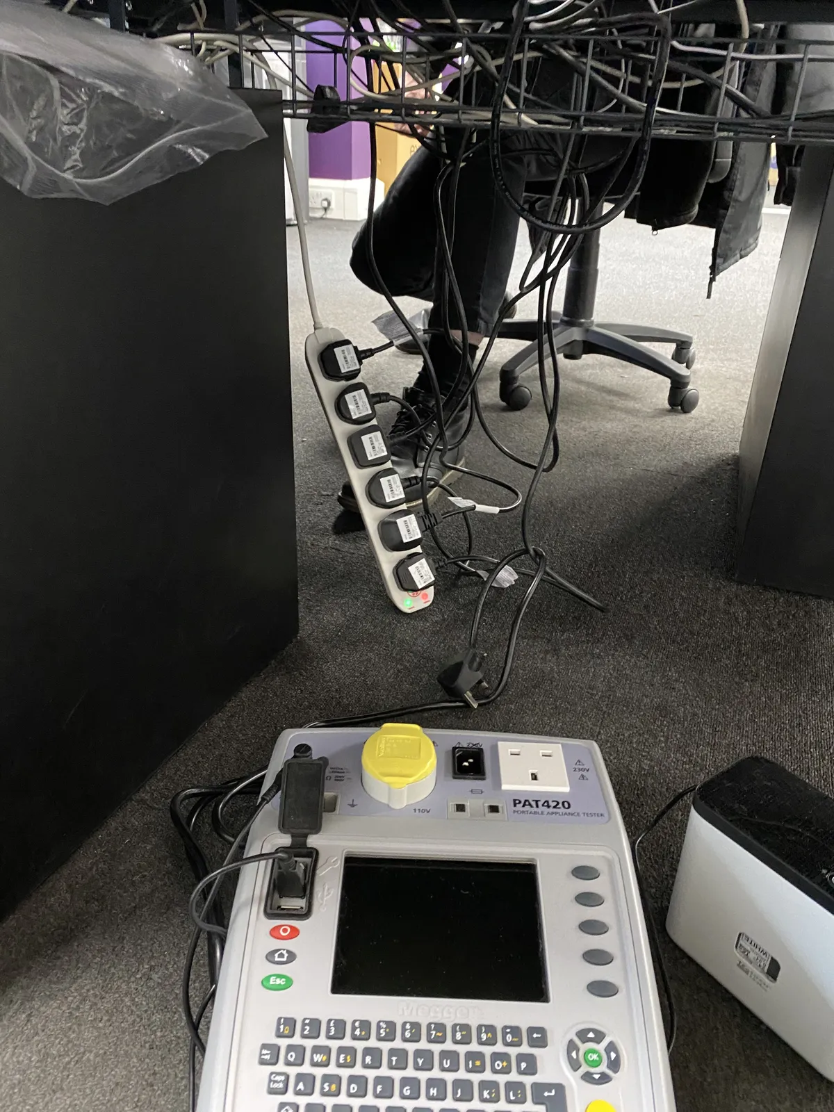 PAT tester and labelled extension lead during portable appliance testing